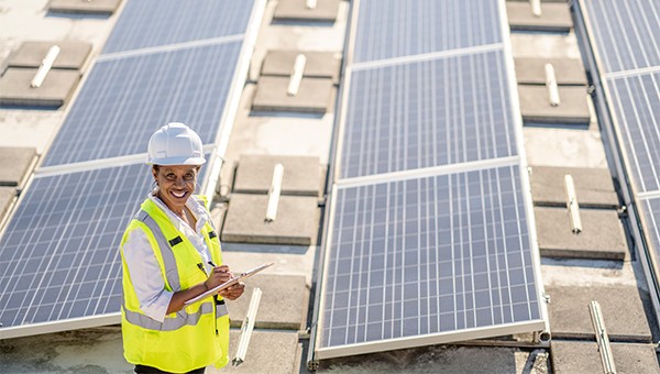 Employee inspecting solar panels