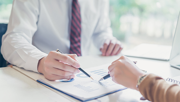 Business people reviewing PPA loan documents