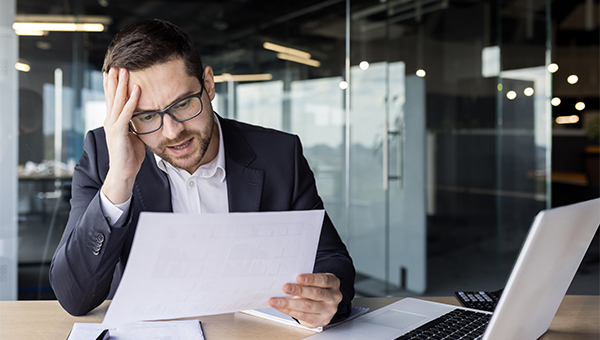 Confused man looking at contract