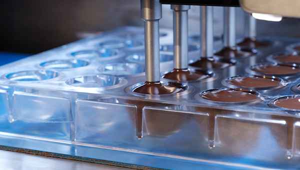 Chocolate factory filling chocolate molds