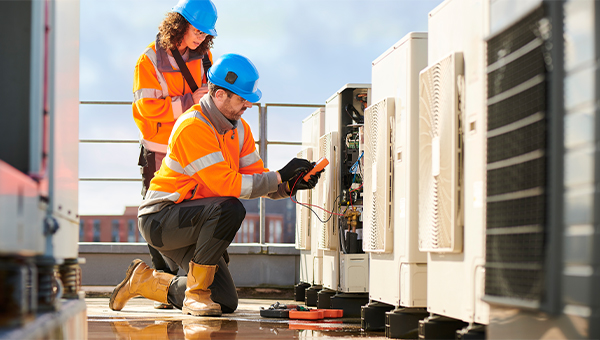 Workers checking energy transformer box