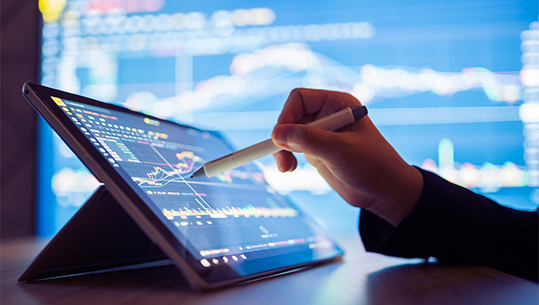 Hand touching iPad displaying NextEra 360 Analytics Software