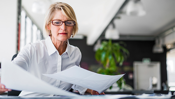 Business woman reviewing documents at her desk