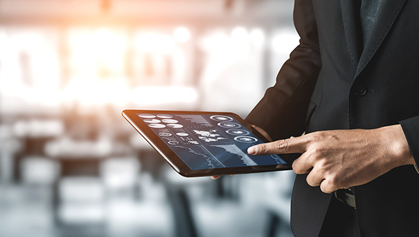 Business man reviewing energy solutions data on a tablet Business man reviewing energy solutions data on a tablet