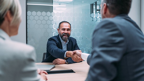 Energy consultant shaking hands with client