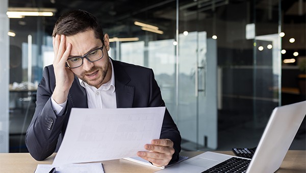 Confused man looking at contract