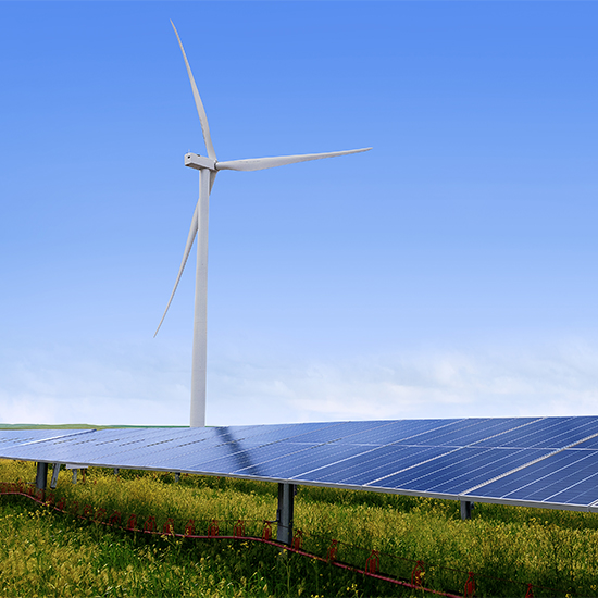 Wind energy tower behind solar panels Wind energy tower behind solar panels
