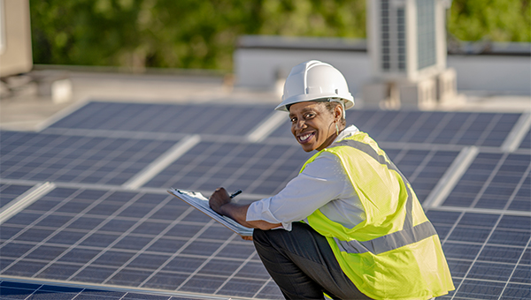 Solar engineer checking the onsite solar panels Solar engineer checking the onsite solar panels