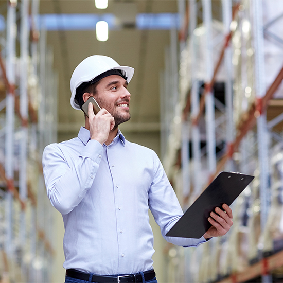Employee in warehouse on tablet Employee in warehouse on tablet