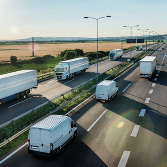 Aerial View of Vans and Trucks driving on the highway Aerial View of Vans and Trucks driving on the highway