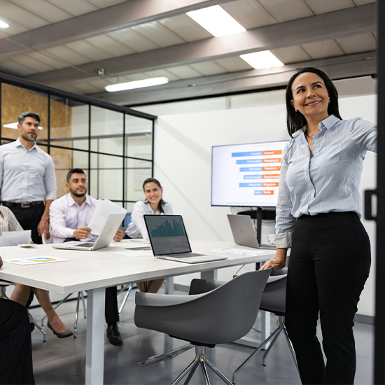 Business meeting with consultants reviewing graph data Business meeting with consultants reviewing graph data