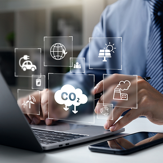 Business man at laptop with renewable energy overlays Business man at laptop with renewable energy overlays