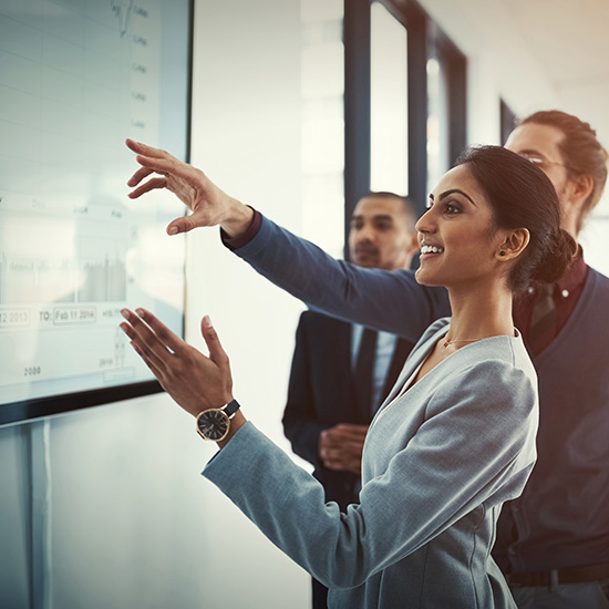 Business people reviewing screen data Business people reviewing screen data